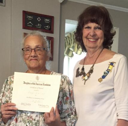 Francois de Lery Chapter, Daughters of the American Revolution held its annual tea at the Arabi home of Faith Moran. Receiving the DAR Community Service Award is Hope Larios (left) for volunteering over 700 hours within one year. Larios volunteers with the St. Bernard Volunteers for Family and Community (the St. Bernard VFC) and at the Community Center of St. Bernard. Presenting the award is Vice-regent Faith Moran.