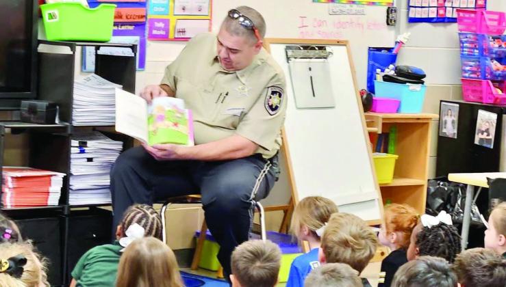 SBSO Corrections Division Dep. Anthony Arnona reads to Davies students.